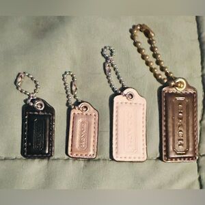Coach Patent Leather Tag Keychain Set - Black, metallic, White, & Brown.